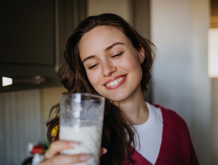 woman holding a cup of milk.jpg